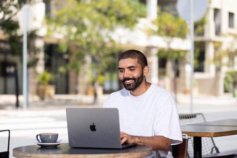 Person working on a laptop without glasses